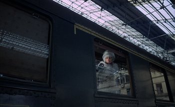Movie still from “F for Fake” (1973), directed by François Reichenbach – A person looking out of a window of a train; Wide shot, Low angle