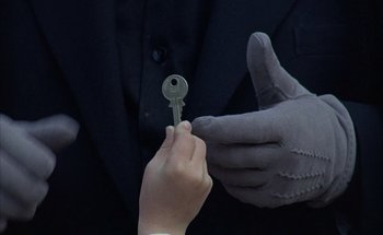 Movie still from “F for Fake” (1973), directed by François Reichenbach – A person is holding a key in their hand; Extreme Close Up shot, High angle