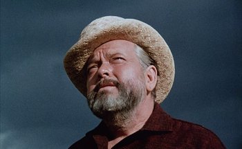 Movie still from “F for Fake” (1973), directed by François Reichenbach – An older man wearing a straw cowboy hat; Close Up shot, Low angle