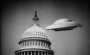 Movie still from “F for Fake” (1973), directed by François Reichenbach – An image of an ufo flying over the capitol building in washington d; Extreme Wide shot, Low angle