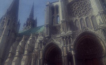 Movie still from “F for Fake” (1973), directed by François Reichenbach – A large cathedral with a large green roof; Extreme Wide shot, High angle