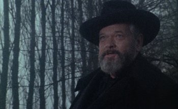Movie still from “F for Fake” (1973), directed by François Reichenbach – An older man with a beard and a hat; Close Up shot, Low angle