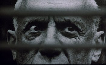 Movie still from “F for Fake” (1973), directed by François Reichenbach – An old man's eyes are seen through a fence; Extreme Close Up shot, Low angle