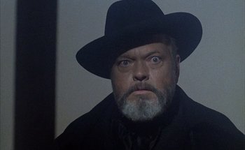 Movie still from “F for Fake” (1973), directed by François Reichenbach – An older man with a beard and a hat; Close Up shot, Low angle