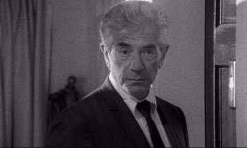 Movie still from “Faces” (1968), directed by John Cassavetes – An older man wearing a suit and tie; Close Up shot, Over the shoulder angle