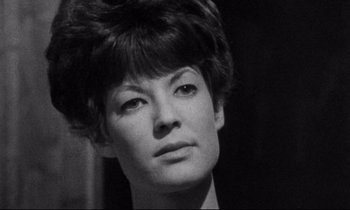 Movie still from “Faces” (1968), directed by John Cassavetes – A person wearing a suit and tie; Close Up shot, Over the shoulder angle