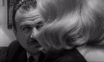 Movie still from “Faces” (1968), directed by John Cassavetes – An older man and a young woman in a room; Close Up shot, Over the shoulder angle