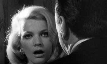 Movie still from “Faces” (1968), directed by John Cassavetes – A black - and - white photo of a woman and a man; Close Up shot, Over the shoulder angle