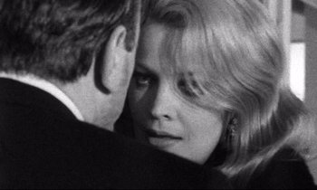 Movie still from “Faces” (1968), directed by John Cassavetes – A man and a woman embracing each other in a black and white photo; Close Up shot, Over the shoulder angle