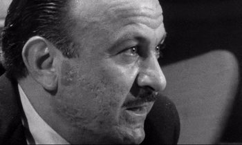 Movie still from “Faces” (1968), directed by John Cassavetes – An old black and white photo of a man looking to his left; Close Up shot, Low angle