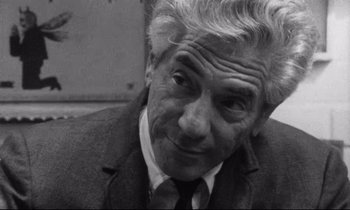 Movie still from “Faces” (1968), directed by John Cassavetes – An older man in a suit and tie looking to his left; Close Up shot, Over the shoulder angle