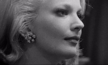 Movie still from “Faces” (1968), directed by John Cassavetes – A black and white photo of a woman's face; Close Up shot, Over the shoulder angle
