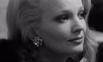Movie still from “Faces” (1968), directed by John Cassavetes – A black - and - white photo of a woman's face; Close Up shot, Over the shoulder angle