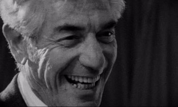 Movie still from “Faces” (1968), directed by John Cassavetes – An older man smiling with his eyes closed; Close Up shot, Over the shoulder angle