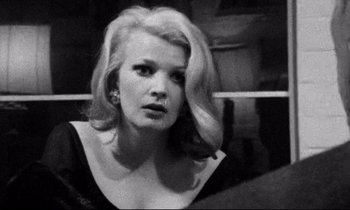 Movie still from “Faces” (1968), directed by John Cassavetes – A black and white photo of a woman with blonde hair; Close Up shot, Over the shoulder angle