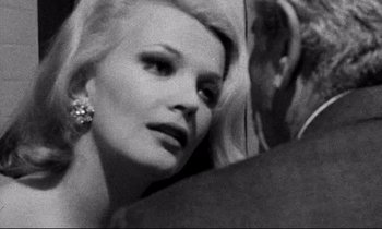 Movie still from “Faces” (1968), directed by John Cassavetes – A black - and - white photo of a woman's face; Close Up shot, Over the shoulder angle