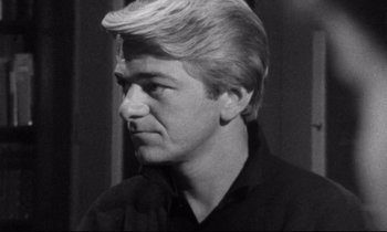 Movie still from “Faces” (1968), directed by John Cassavetes – Black and white photograph of a man in a black shirt; Close Up shot, Low angle