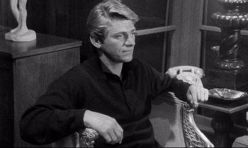 Movie still from “Faces” (1968), directed by John Cassavetes – Black and white photograph of a man sitting in a chair; Medium shot, High angle