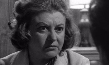 Movie still from “Faces” (1968), directed by John Cassavetes – An older woman is looking at the camera; Close Up shot, Over the shoulder angle