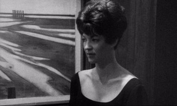 Movie still from “Faces” (1968), directed by John Cassavetes – A black and white photo of a woman in a black dress; Medium shot, Over the shoulder angle