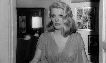 Movie still from “Faces” (1968), directed by John Cassavetes – A black - and - white photo of a woman with long blonde hair; Close Up shot, Over the shoulder angle