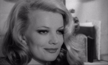 Movie still from “Faces” (1968), directed by John Cassavetes – A black - and - white photo of a woman with long hair; Close Up shot, Over the shoulder angle