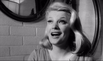 Movie still from “Faces” (1968), directed by John Cassavetes – A black - and - white photo of a woman smiling; Close Up shot, Low angle