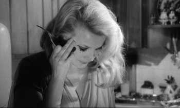 Movie still from “Faces” (1968), directed by John Cassavetes – A beautiful woman talking on a cell phone while holding her hand to her ear; Close Up shot, High angle