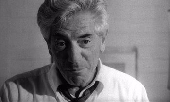 Movie still from “Faces” (1968), directed by John Cassavetes – An older man wearing a neck tie looking at the camera; Close Up shot, Low angle