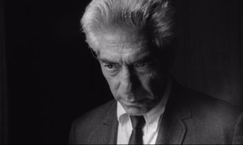 Movie still from “Faces” (1968), directed by John Cassavetes – An older man in a suit and tie looking sad; Close Up shot, Low angle