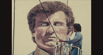 Movie still from “Faces Places” (2017), directed by Agnès Varda – A man is painting a large portrait of a man; Close Up shot, Low angle