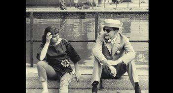Movie still from “Faces Places” (2017), directed by Agnès Varda – A man and a woman sitting next to each other on steps; Medium shot, High angle