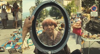Movie still from “Faces Places” (2017), directed by Agnès Varda – An older woman looking at herself in a mirror; Medium shot, Over the shoulder angle