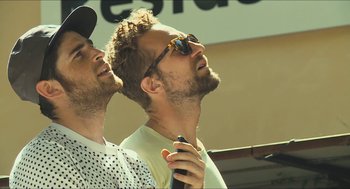 Movie still from “Faces Places” (2017), directed by Agnès Varda – Two men are looking up into the sky; Close Up shot, Low angle