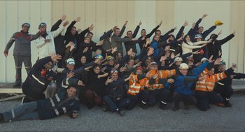 Movie still from “Faces Places” (2017), directed by Agnès Varda – A large group of people posing for a picture; Extreme Wide shot, High angle