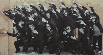 Movie still from “Faces Places” (2017), directed by Agnès Varda – A group of people that are posing for a picture; Wide shot, High angle