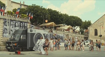 Movie still from “Faces Places” (2017), directed by Agnès Varda – A group of people standing next to each other near a camera; Extreme Wide shot, High angle