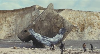 Movie still from “Faces Places” (2017), directed by Agnès Varda – A man and a dog in front of a rock formation; Extreme Wide shot, Low angle
