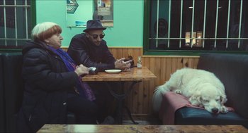 Movie still from “Faces Places” (2017), directed by Agnès Varda – Two people sitting at a table in a restaurant; Wide shot, High angle