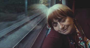 Movie still from “Faces Places” (2017), directed by Agnès Varda – A woman with her head resting on a train window; Close Up shot, High angle