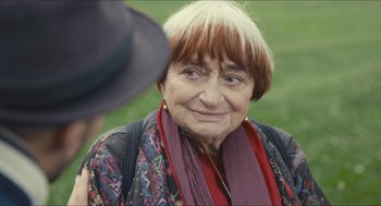 Movie still from “Faces Places” (2017), directed by Agnès Varda – An older woman is smiling for the camera; Close Up shot, Over the shoulder angle
