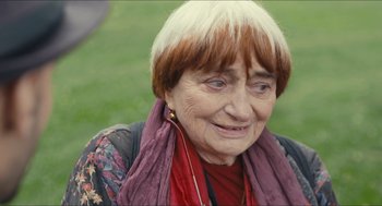 Movie still from “Faces Places” (2017), directed by Agnès Varda – An older woman wearing a red scarf and a floral shirt; Close Up shot, High angle