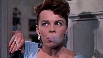 Movie still from “Fahrenheit 9/11” (2004), directed by Michael Moore – A person smoking a cigarette; Close Up shot, Low angle