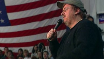 Movie still from “Fahrenheit 9/11” (2004), directed by Michael Moore – A man with a hat is speaking into a microphone; Close Up shot, High angle