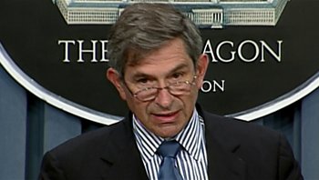 Movie still from “Fahrenheit 9/11” (2004), directed by Michael Moore – A person wearing a suit and tie; Close Up shot, Over the shoulder angle