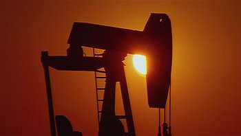 Movie still from “Fahrenheit 9/11” (2004), directed by Michael Moore – An image of an oil well at sunset or sunrise; Extreme Wide shot, Low angle