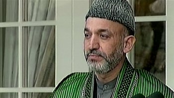 Movie still from “Fahrenheit 9/11” (2004), directed by Michael Moore – An older man wearing a green and black outfit; Close Up shot, Low angle