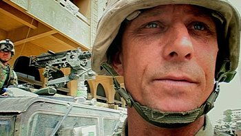 Movie still from “Fahrenheit 9/11” (2004), directed by Michael Moore – A person wearing a hat; Extreme Close Up shot, Low angle