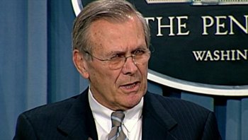 Movie still from “Fahrenheit 9/11” (2004), directed by Michael Moore – An older man wearing a suit and tie; Close Up shot, Low angle