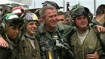 Movie still from “Fahrenheit 9/11” (2004), directed by Michael Moore – A group of men standing next to each other; Medium shot, Low angle